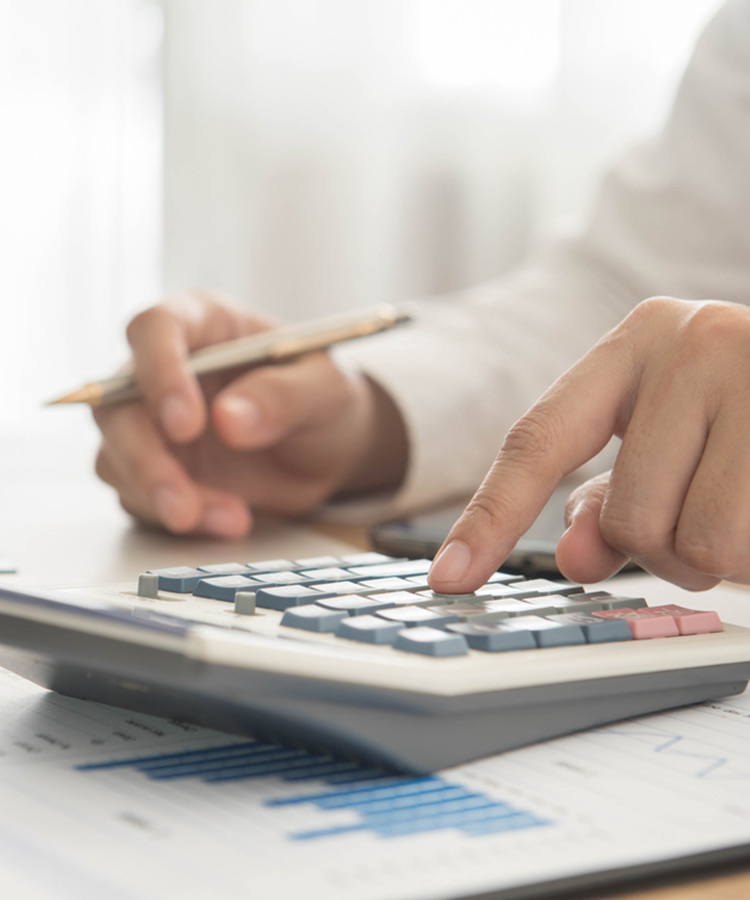 Photo of a person calculating with a pocket calculator.